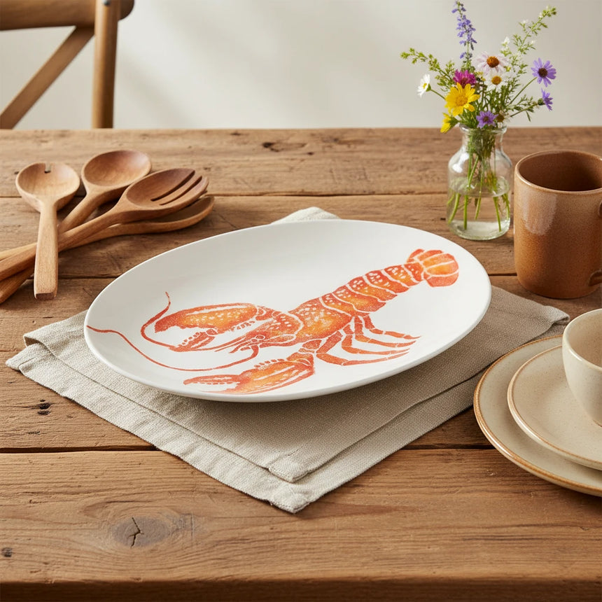 White plate with a red lobster design on a white background