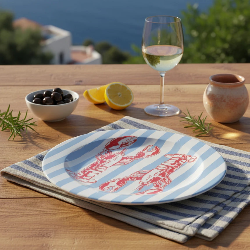 Round plate with red lobster design on a blue and white striped background