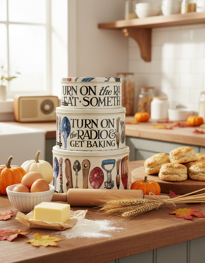 Set of three round cake tins with vintage baking gadget illustrations, in varying sizes, stacked together.