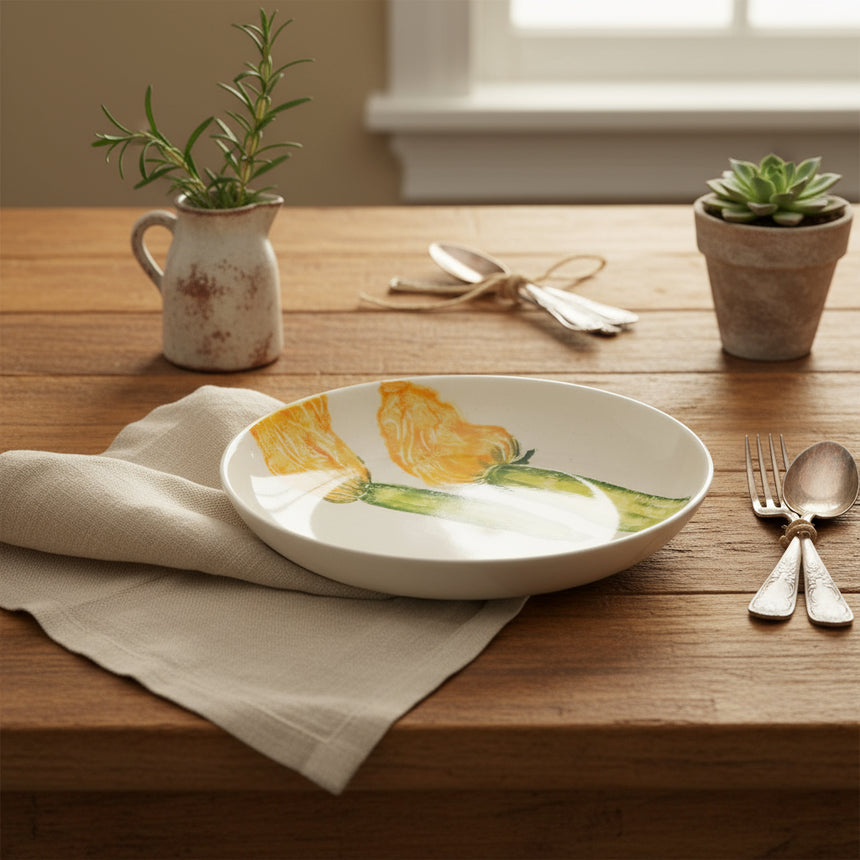 Small white plate with yellow flowers and green stems on a white background
