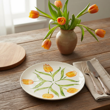 Round ceramic plate with orange tulip design on a white background