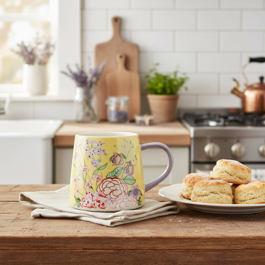 Yellow mug with floral design on a white background