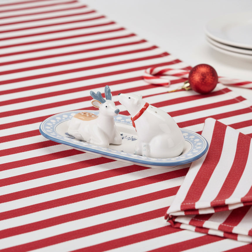 Two white animal figurines on a decorative plate with a white background