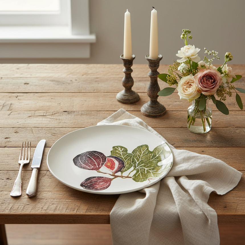 Round ceramic plate with fig design on a white background