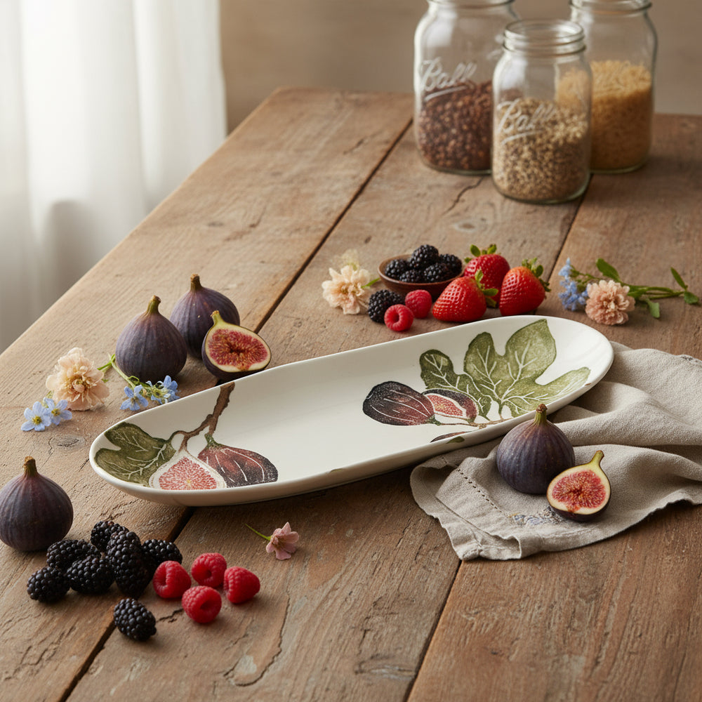 Decorative ceramic bowl with fig design on a white background