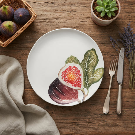 Round ceramic plate with a fig design on a white background