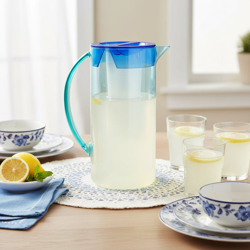 A clear acrylic pitcher with Light blue coloring and a contrasting cobalt blue lid.
