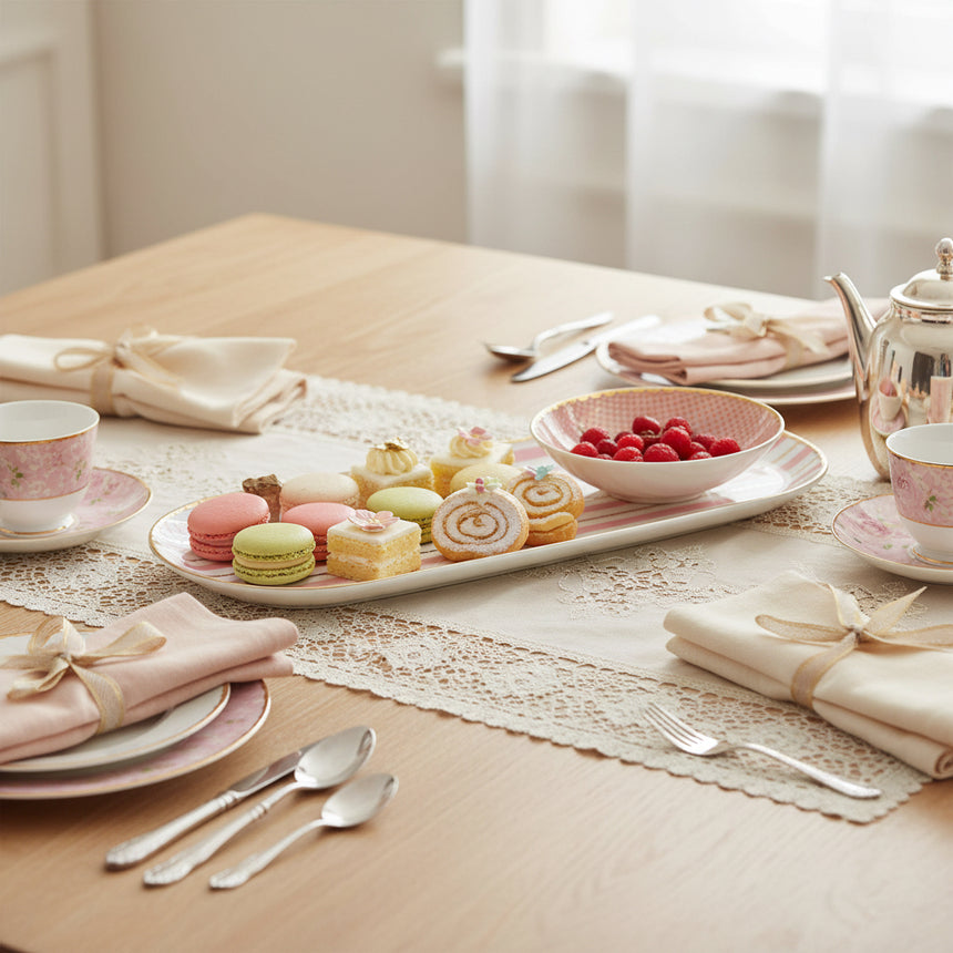 Set of two ceramic dishes with pink and white striped design on a white background