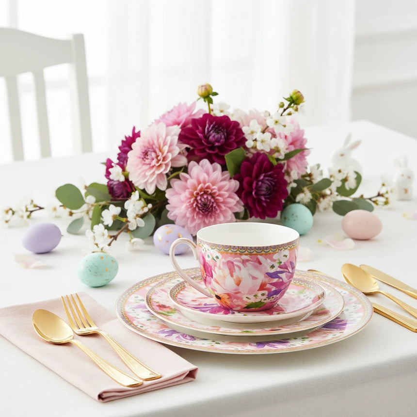 Colorful floral teacup and saucer set on a white background