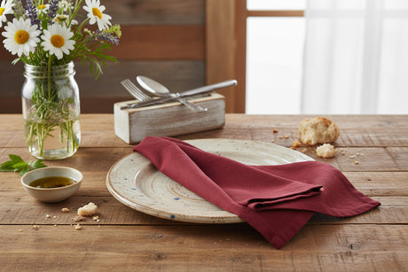 Folded burgundy napkin on a white background