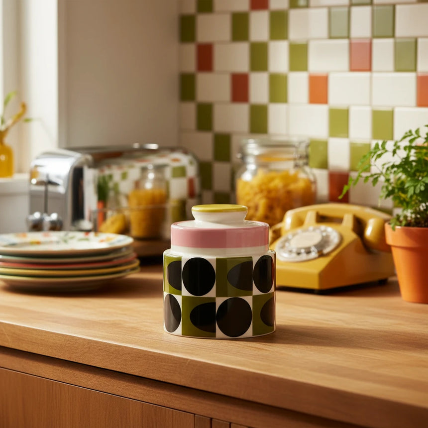 Decorative jar with black dot pattern on a beige background