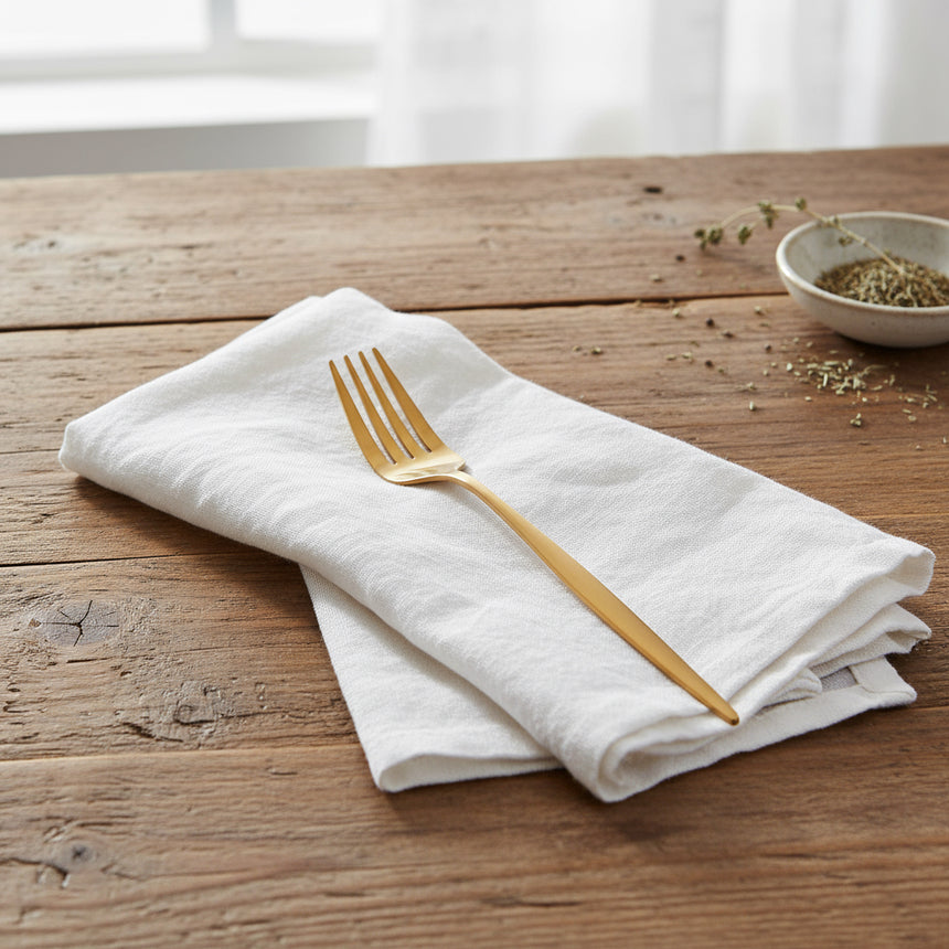 Gold fork on a white background