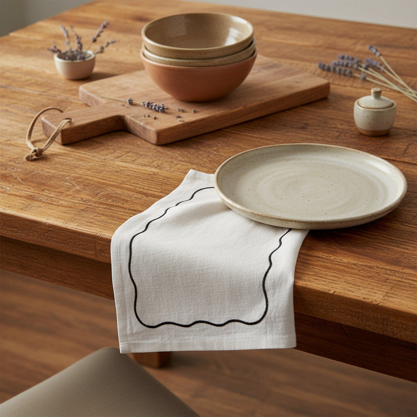 White napkin with a black wavy line on a white background