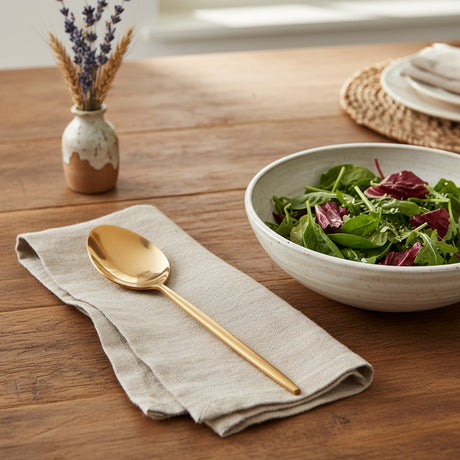 Gold spoon on a white background