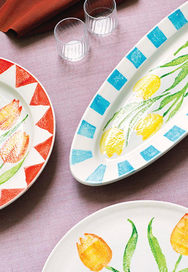 Decorative plates with floral designs on a tablecloth