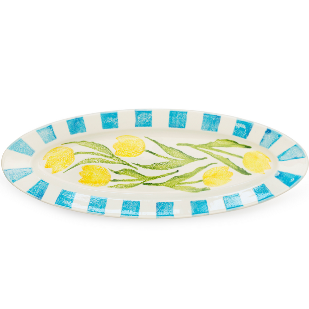 Decorative plate with yellow tulips and blue stripes on a white background