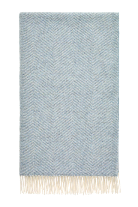 A duck egg blue wool throw with a classic herringbone pattern and tassels at the bottom.