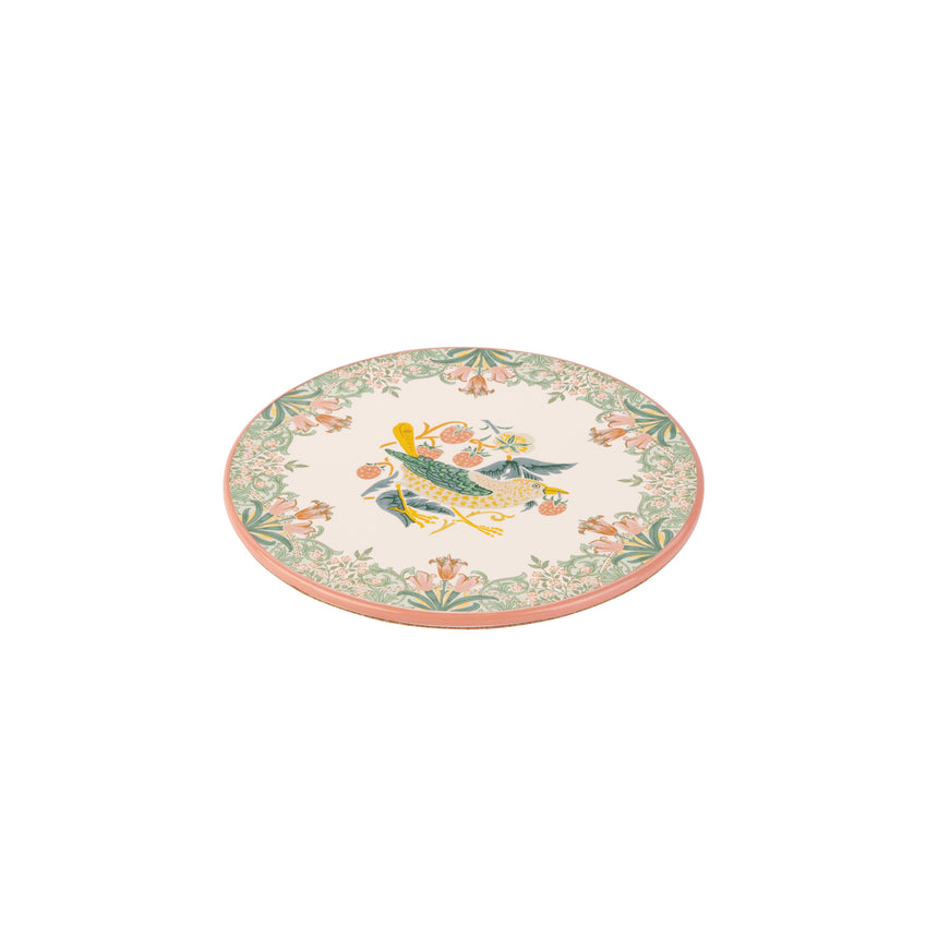 A round ceramic trivet with a cream-colored background, featuring a central illustration of a green bird with yellow accents and a floral border in green, pink, and orange.