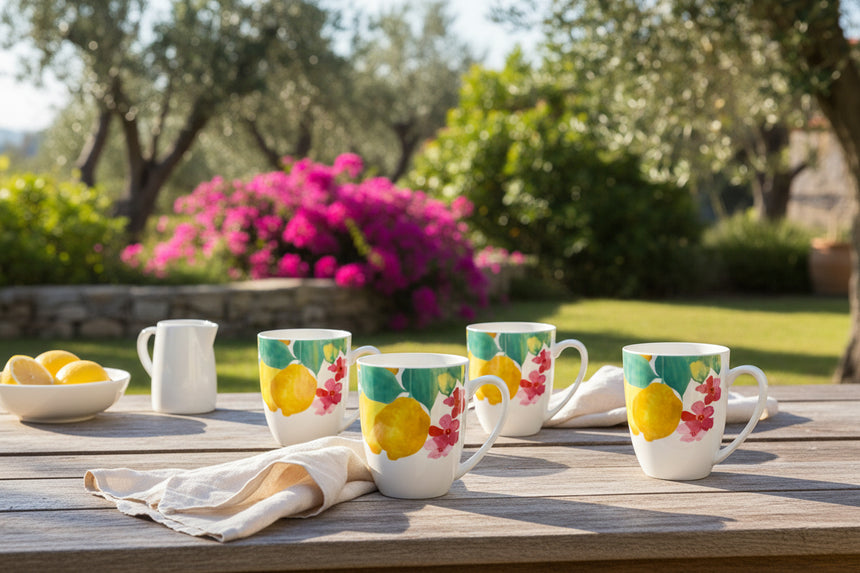 Set of four mugs with lemon and floral design on a white background