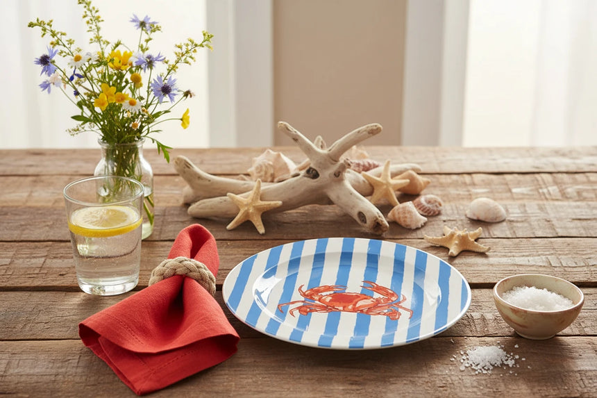 Round plate with blue and white striped border and red crab design