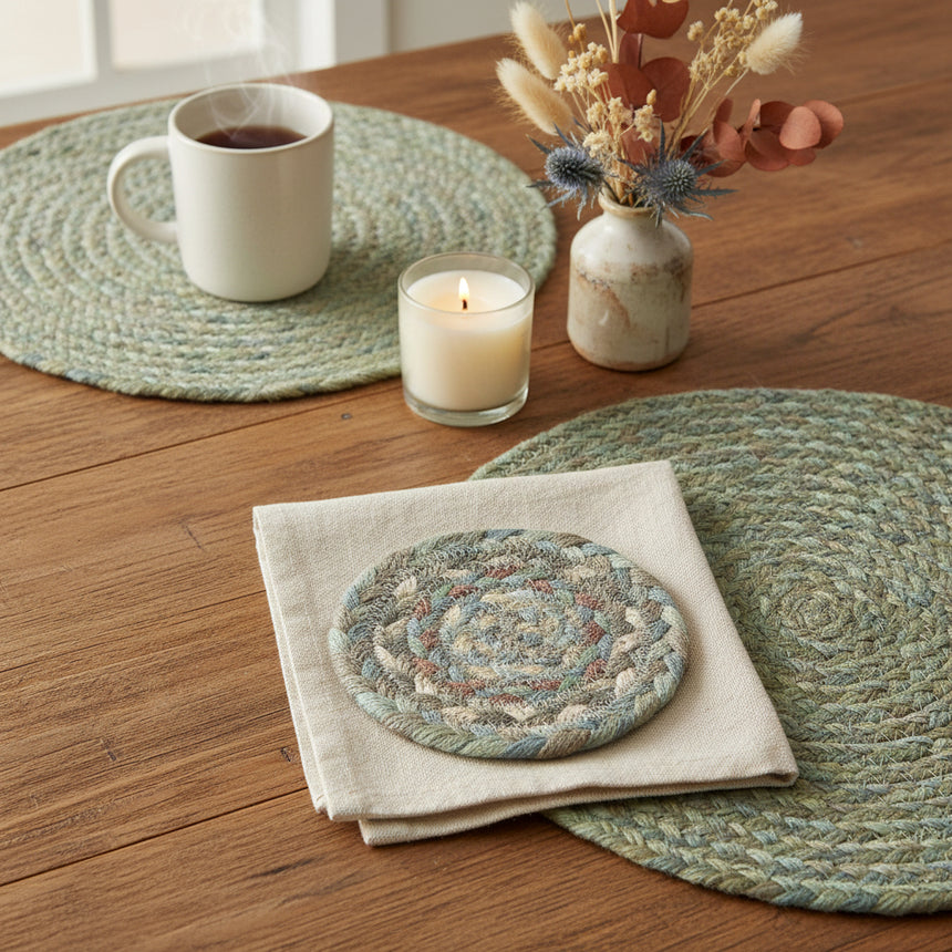 Round braided coaster with multicolor pattern on a white background