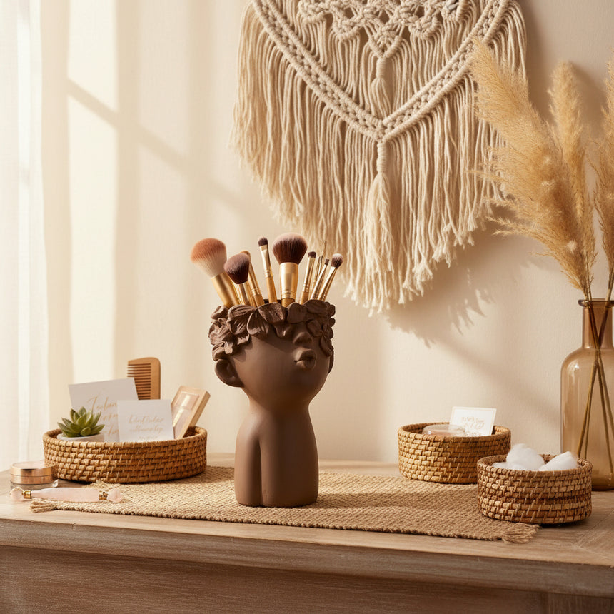 A brown cement vase featuring a sculpted lady's head and upper body, designed to resemble a kissing face, intended for use as a planter for small plants or decoration items.
