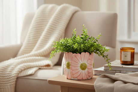 Decorative plant pot with floral design on a white background