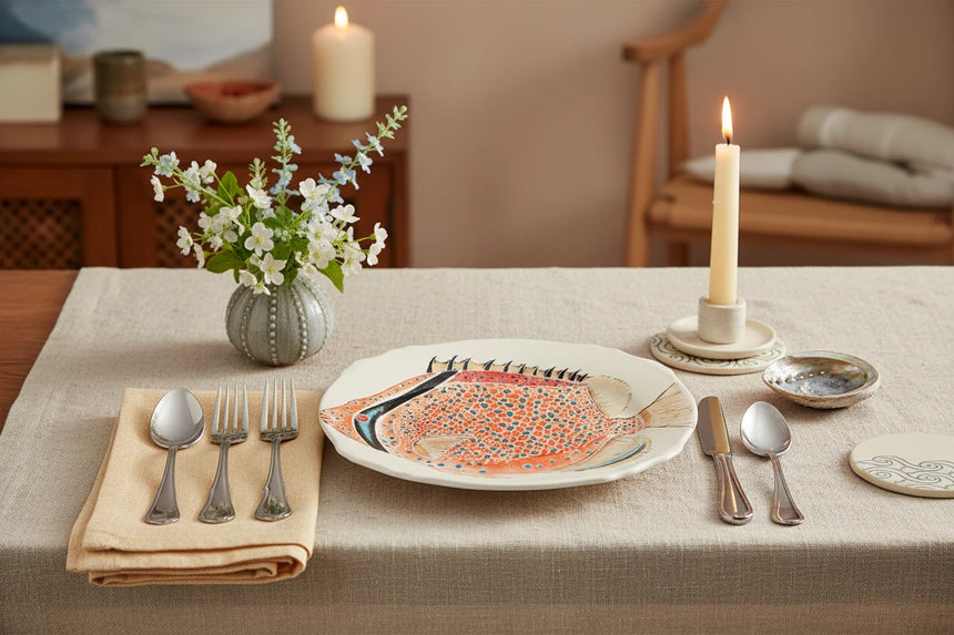 Decorative plate with a fish design on a white background
