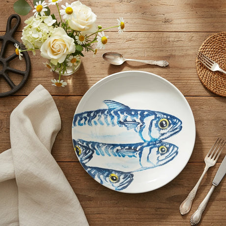 Round ceramic plate with blue fish design on a white background
