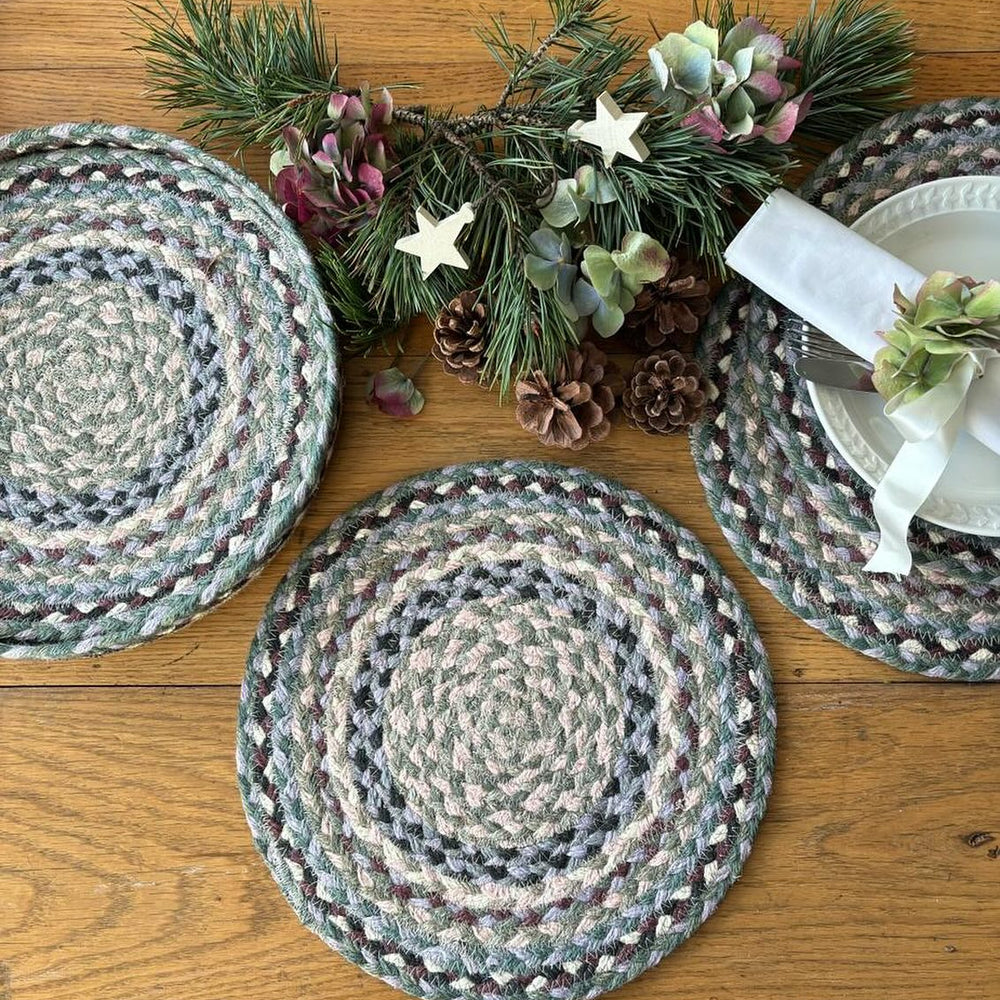 Braided placemats on a wooden table with decorative elements