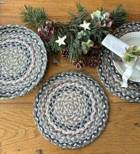 Braided placemats on a wooden table with decorative elements