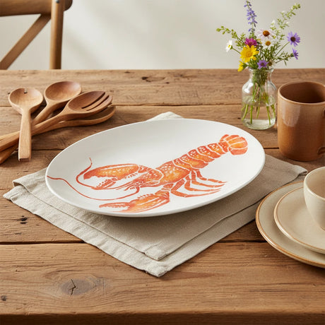 White plate with a red lobster design on a white background