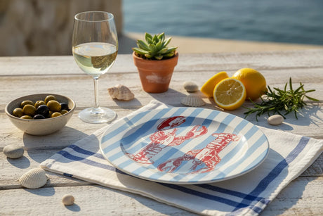 Round plate with red lobster design on a blue and white striped background