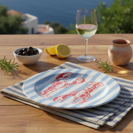 Round plate with red lobster design on a blue and white striped background