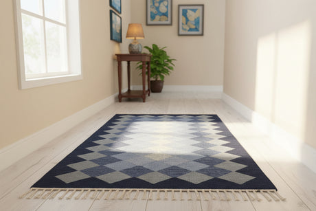 Blue and white checkered rug with tassels on a light wooden floor