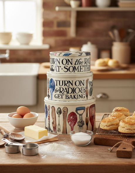 Set of three decorative containers with kitchen-themed designs and text on a white background