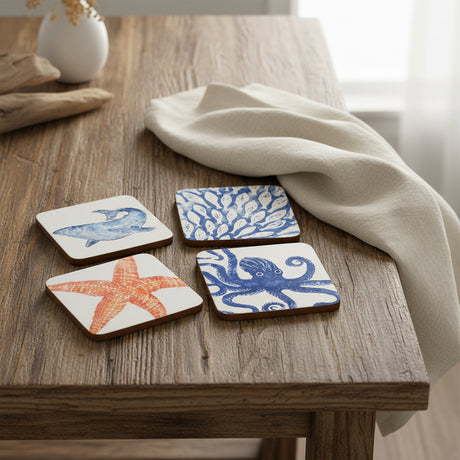 Set of four coasters with ocean-themed designs on a white background