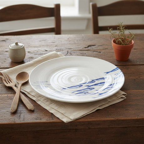 White plate with blue fish pattern on a white background
