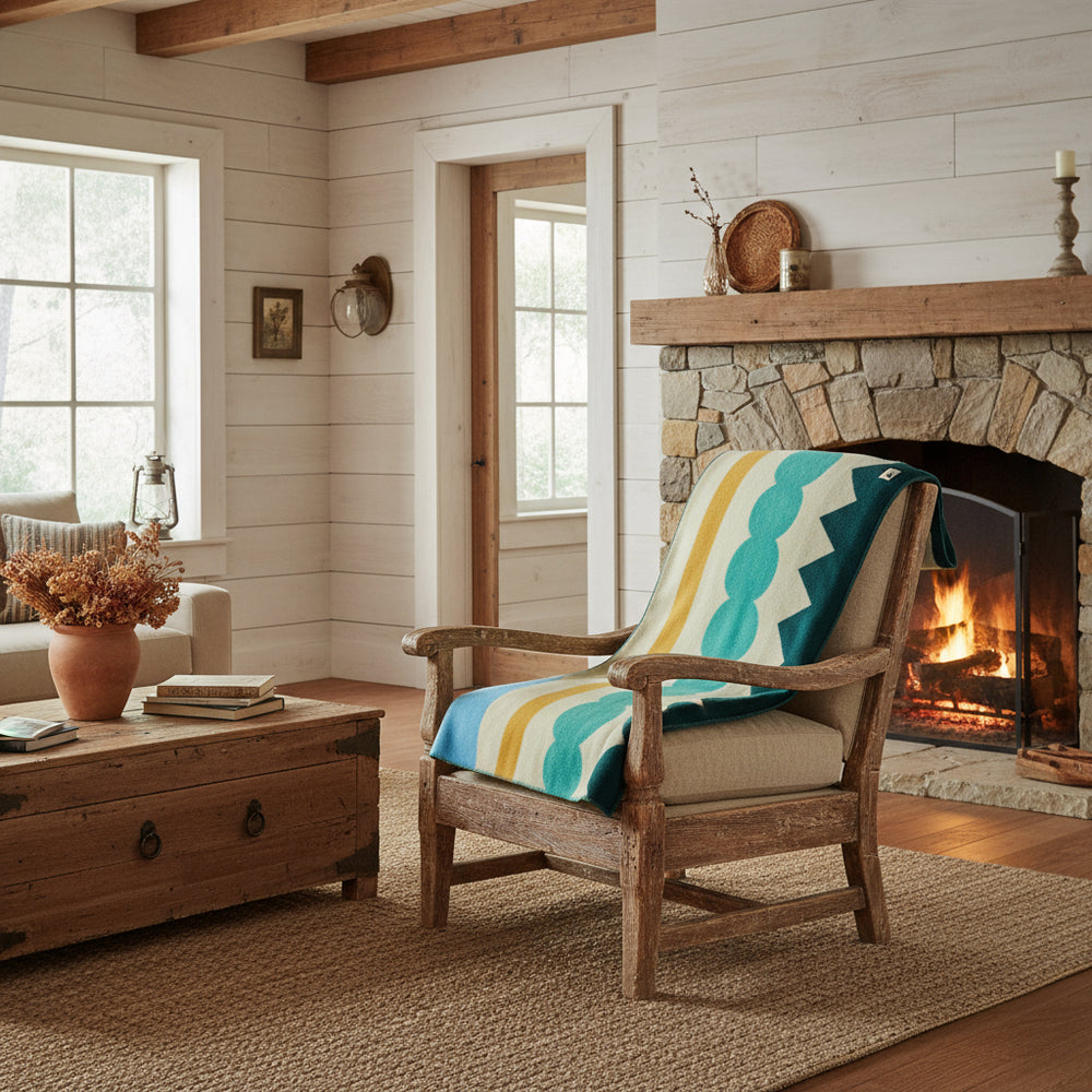 wool blanket with abstract design featuring a red circle, blue stripes, and green shapes on a beige background.