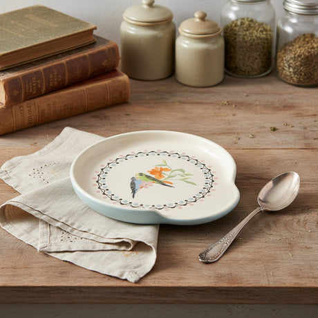 Spoon rest  with a bird and floral design on a white background