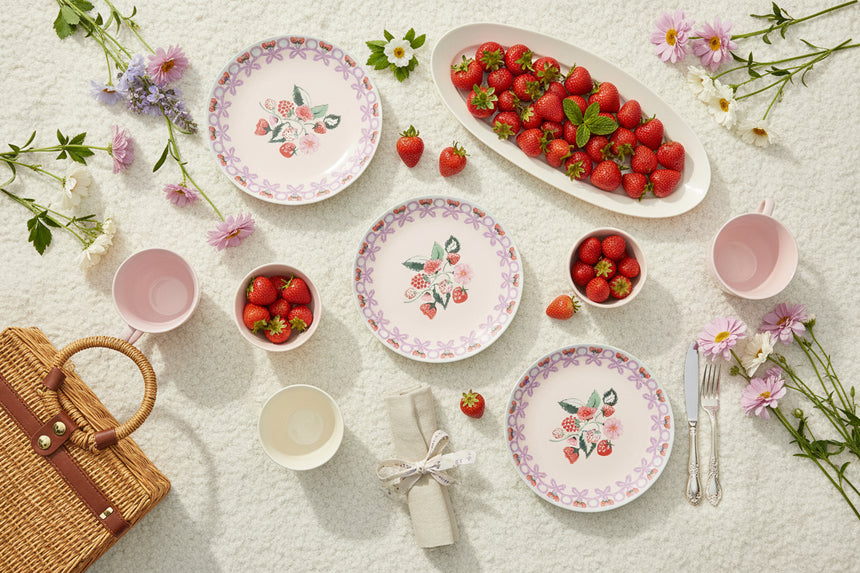 Decorative plate with floral and berry design on a white background