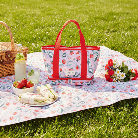 Floral-patterned tote bag with red handles on a light pink background
