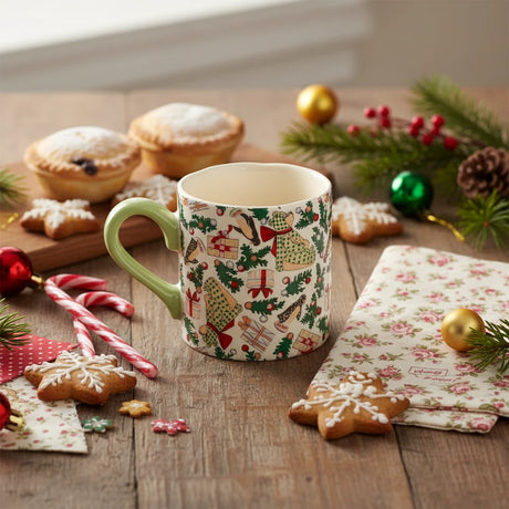 Mug with Christmas-themed design featuring trees, presents, and animals on a white background.