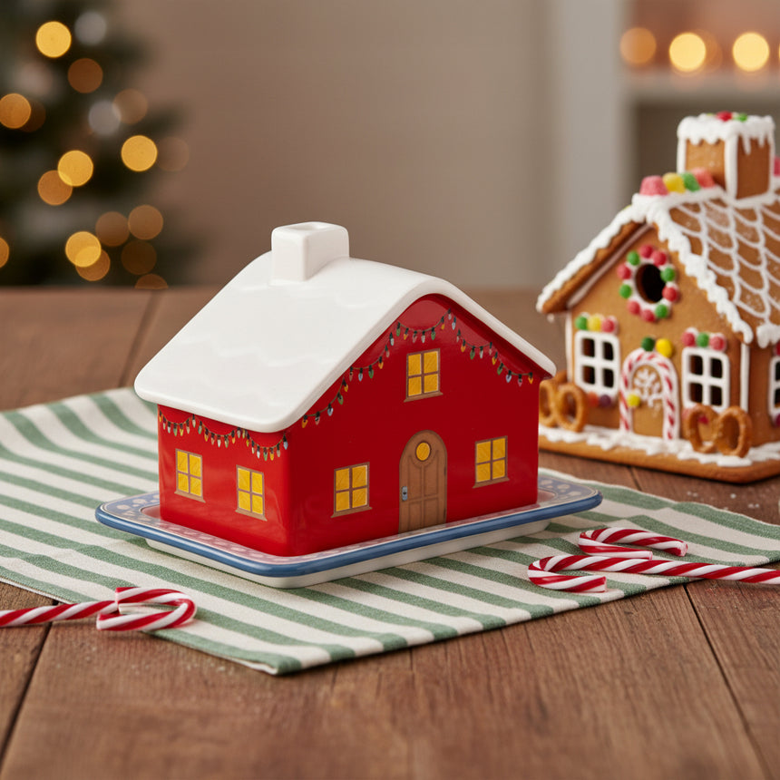 Red house-shaped  butter dish with white roof on a white background