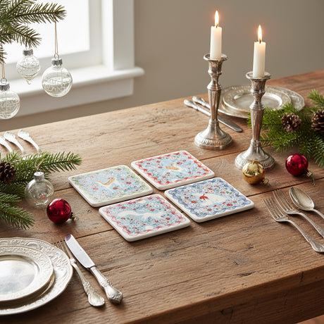 Set of four floral coasters on a white background