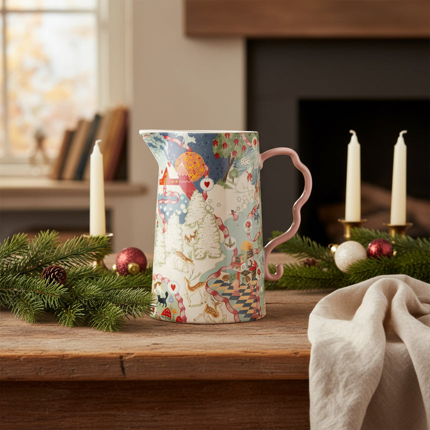 Decorative ceramic pitcher with a colorful design on a white background