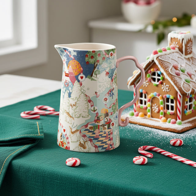 Colorful ceramic pitcher with a patterned design on a white background