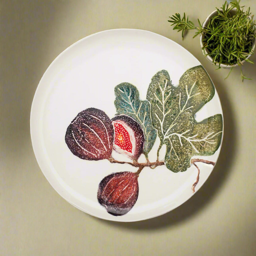 Round ceramic plate with fig design on a white background