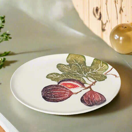 Round ceramic plate with fig design on a white background
