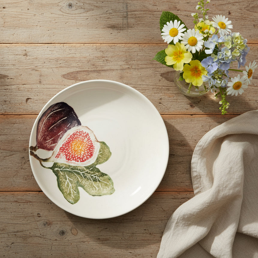 White ceramic plate with fig illustrations on a white background